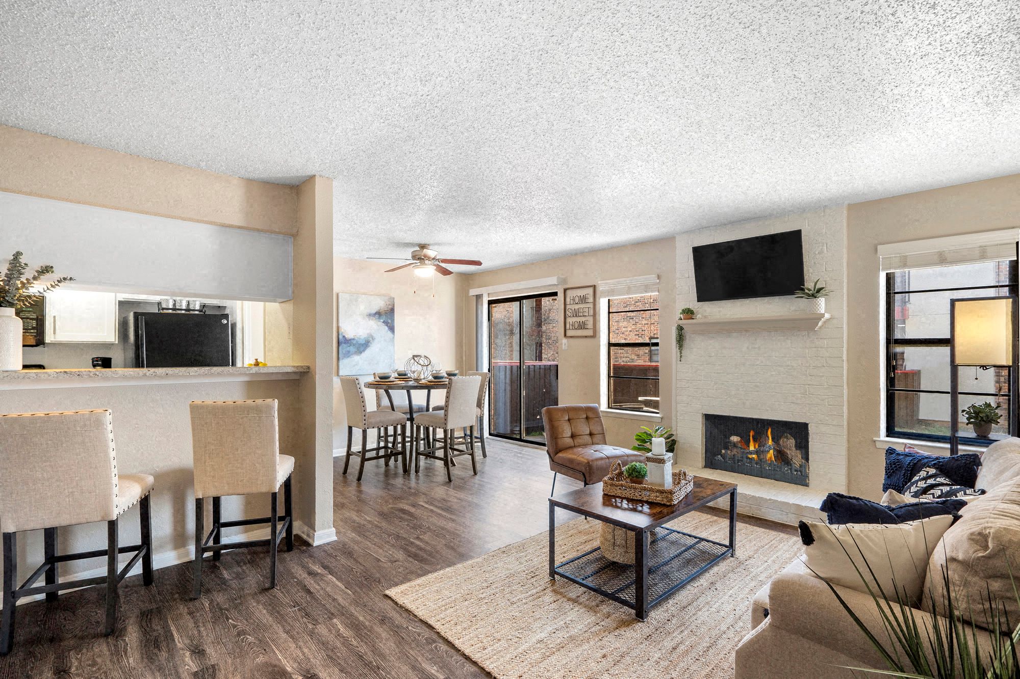 an open living room with a fireplace and a dining room table