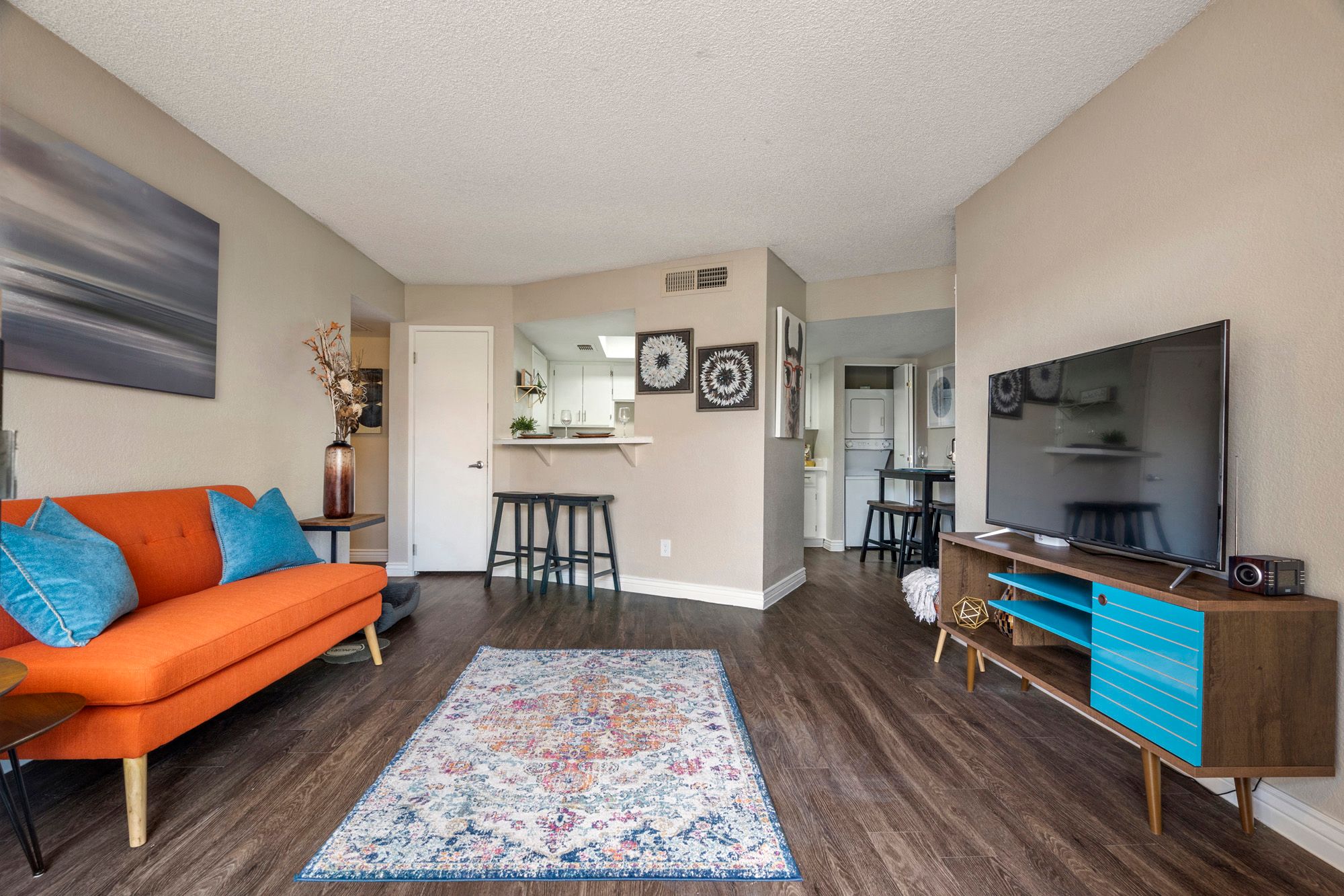 a living room with an orange couch and a television