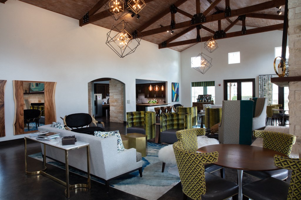 a living room with couches chairs and tables and a fireplace