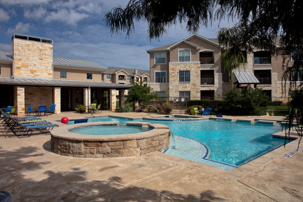 our apartments have a large swimming pool and patio with chairs
