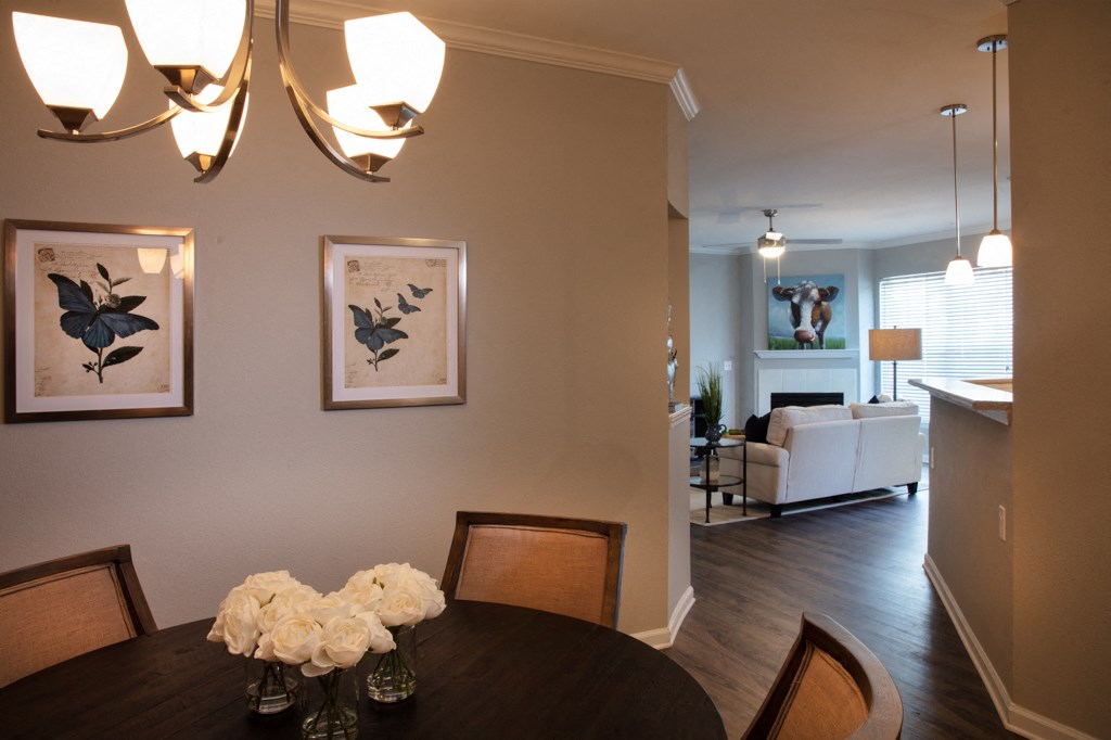 the view from the dining room into the living room and the kitchen