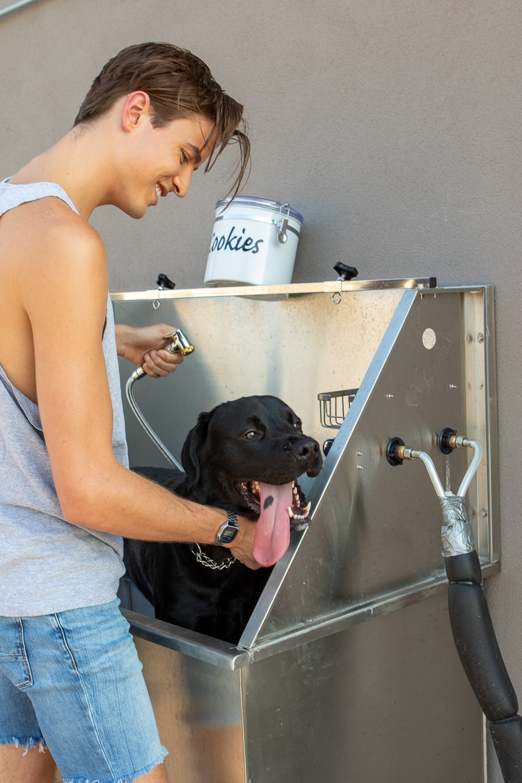 a man washes his dog in a bathtub
