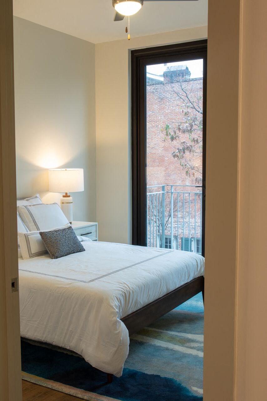 a bedroom with a bed and a window