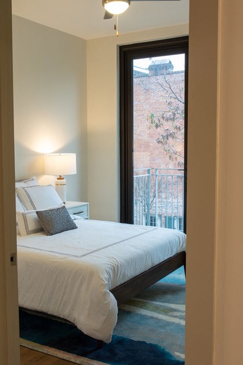 a bedroom with a bed and a window