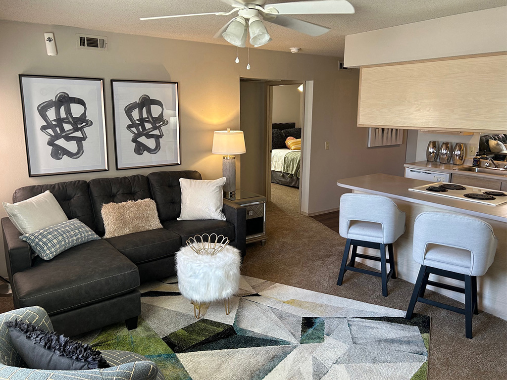a living room with a ceiling fan and a rug