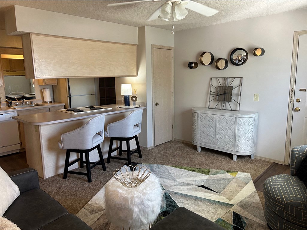 the view of a living room and a kitchen with an island