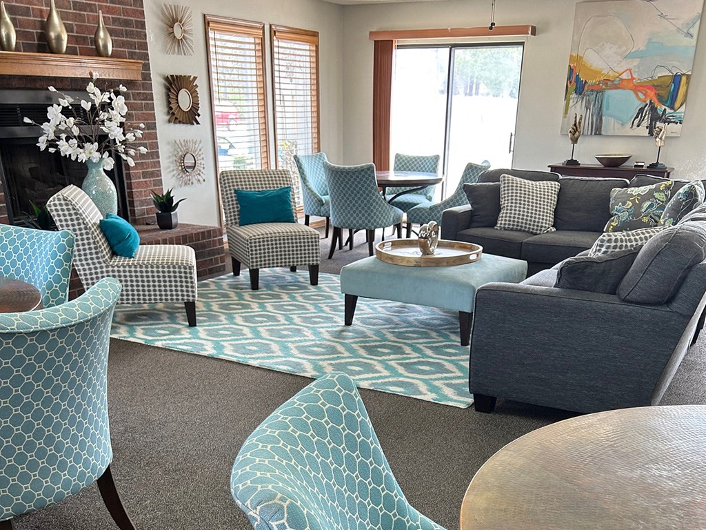 a living room with blue and white furniture and a fireplace