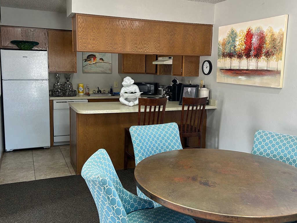 a kitchen and dining room with a table and chairs