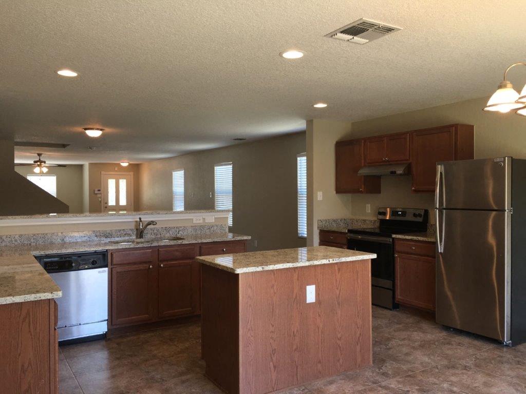 a kitchen with stainless steel appliances and wooden cabinets