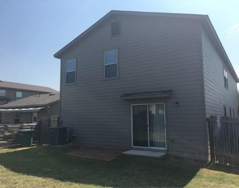 a white house with a yard and a gate