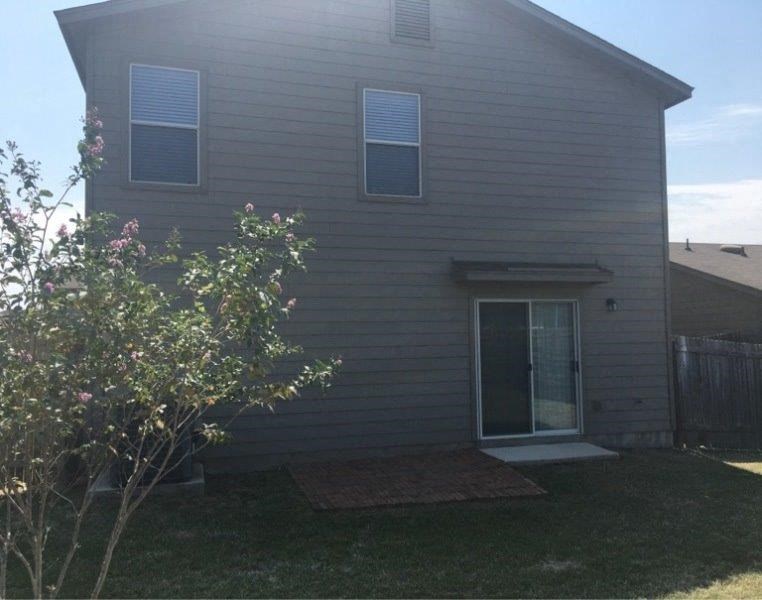 a white house with a yard and a door