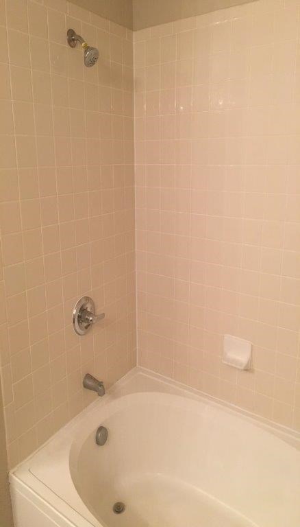 a bathroom with a white tub and a sink