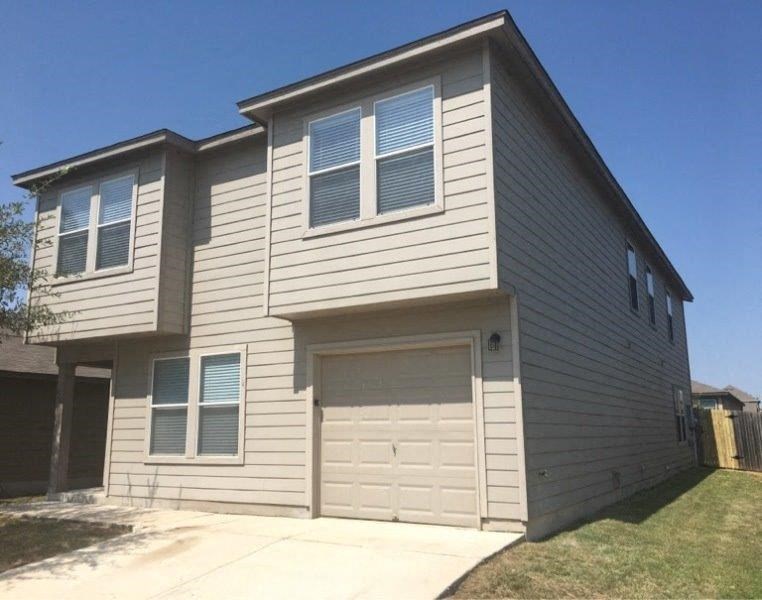 a white house with a white garage door