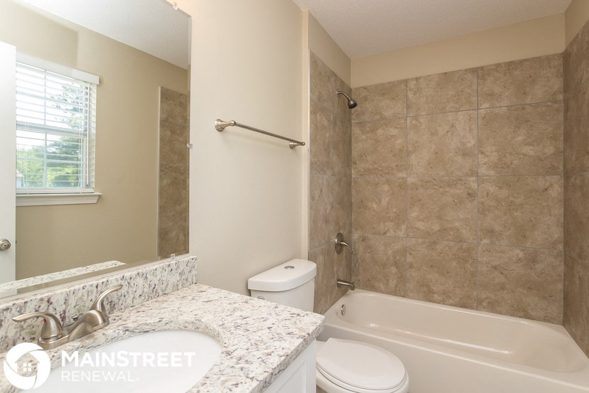 a bathroom with a tub and a sink and a toilet