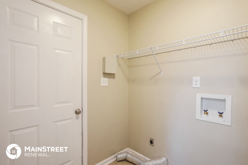 a small closet with a white door and a white closet door to a white room