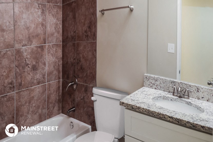 a bathroom with a toilet and a sink and a shower