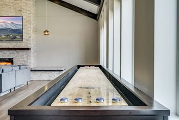 Residents can enjoy a good game of shuffle board in the clubhouse at Ascend at Woodbury in Woodbury, MN