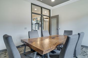 Conference room with table, office chairs, and television