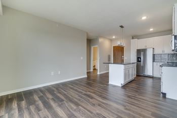 Large open dining area with hardwood style flooring at Ascend at Woodbury in Woodbury, MN
