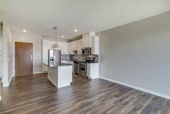 Large open dining area with hardwood style flooring at Ascend at Woodbury in Woodbury, MN