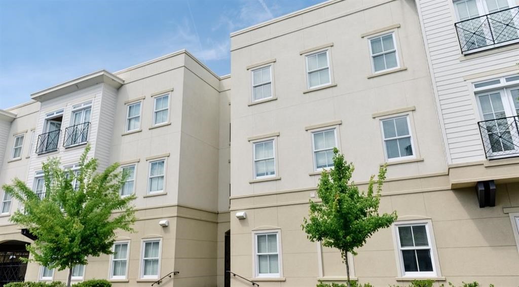 a couple of white buildings with trees in front of them