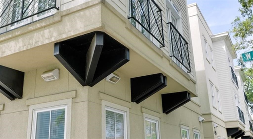 a building with three windows and a balcony
