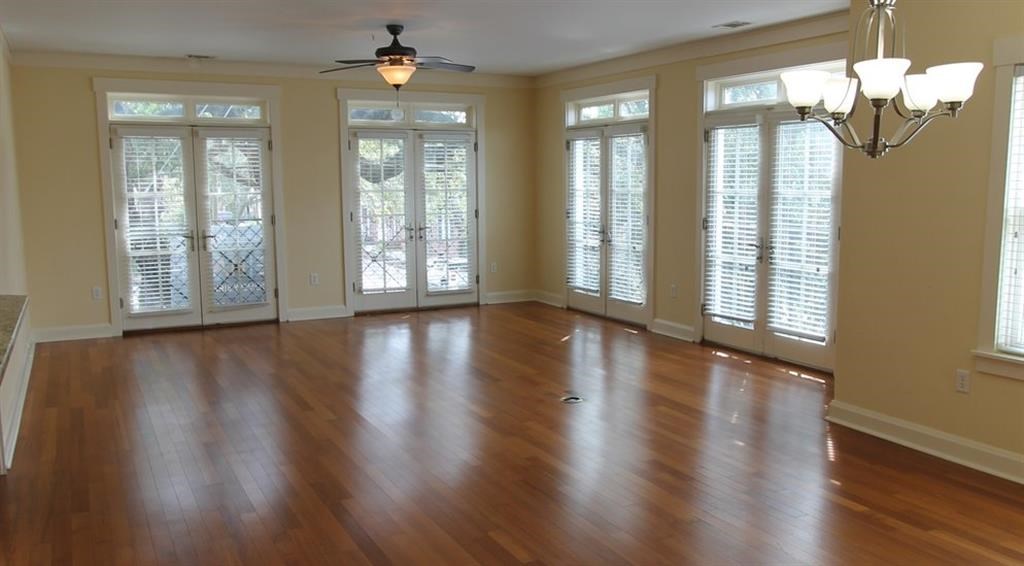 an empty living room with a hard wood floor