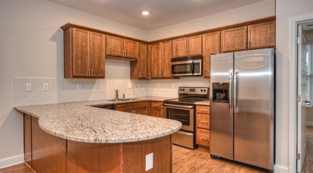 a kitchen with stainless steel appliances and a granite counter top