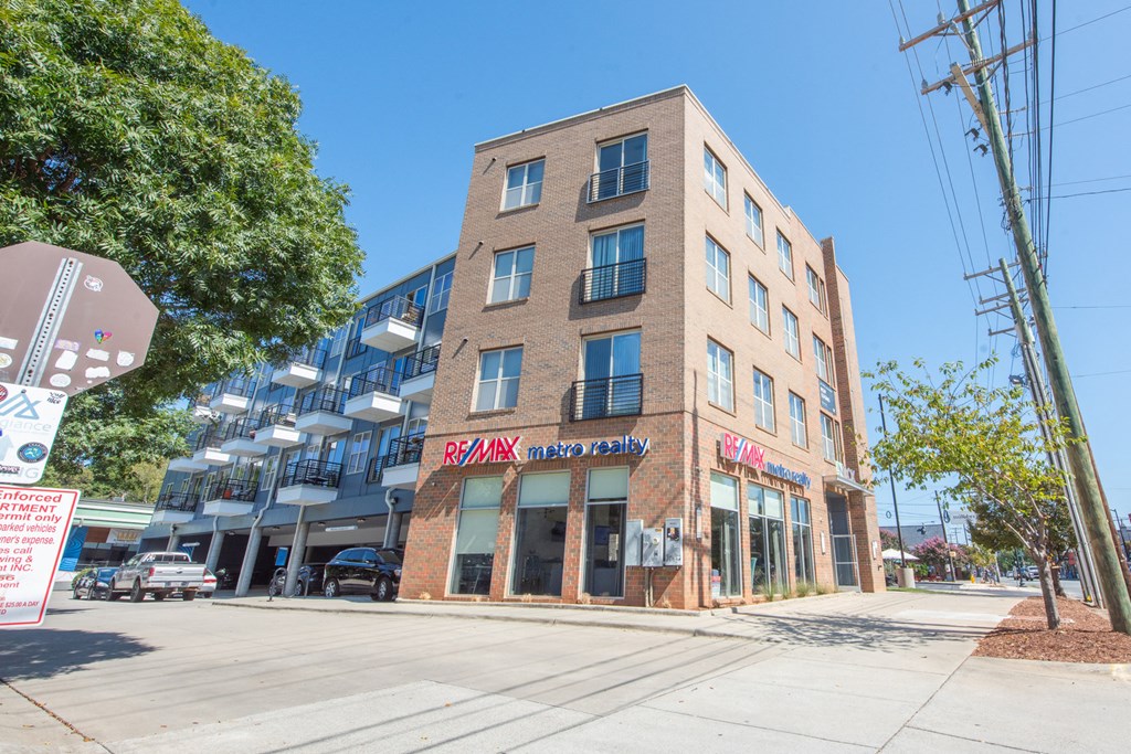 a building on the corner of a street with a stop sign