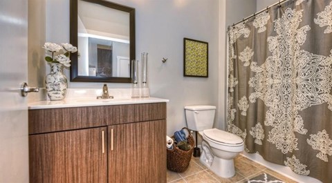 a bathroom with a toilet and a sink and a shower