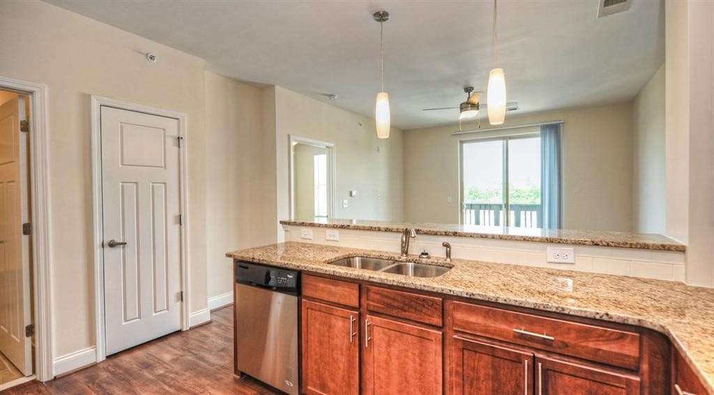 a kitchen with wooden cabinets and a sink and a window