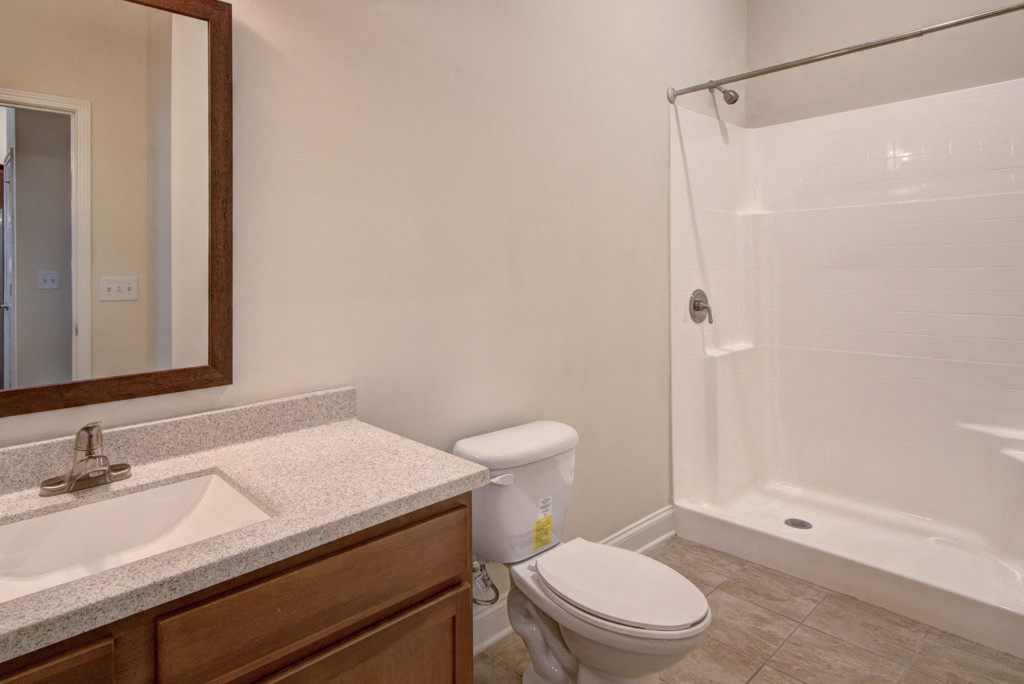 a bathroom with a sink toilet and a shower