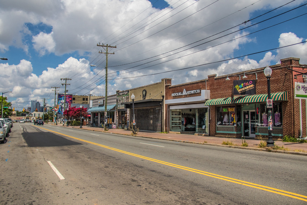 a city street with businesses on the side of the road
