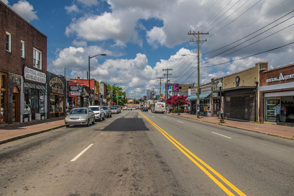 a city street with cars parked on the side of the road