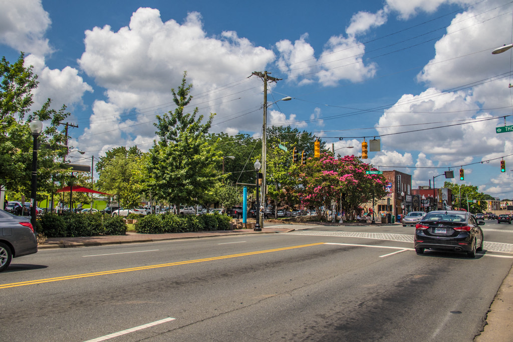 a city street with cars driving down it