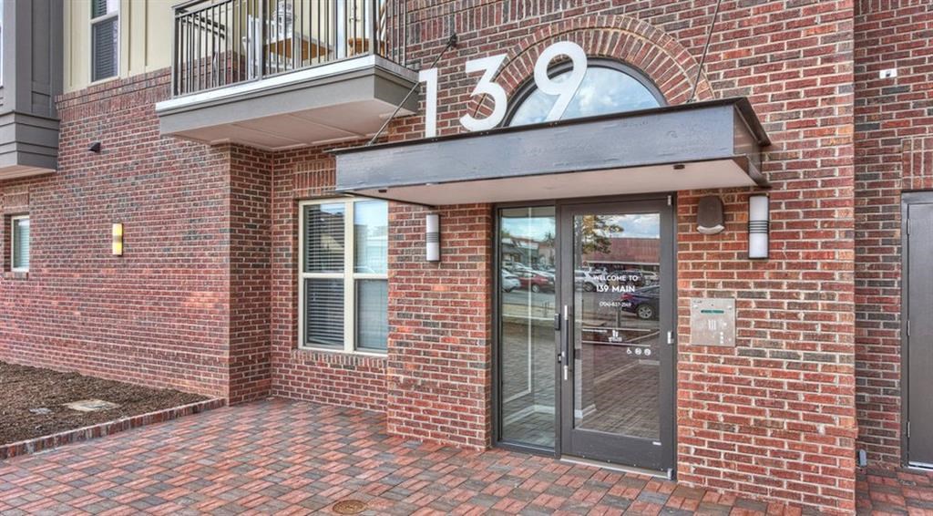 the front of a brick building with a glass door