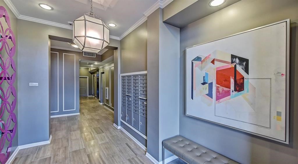 a hallway with a painting on the wall and a bench