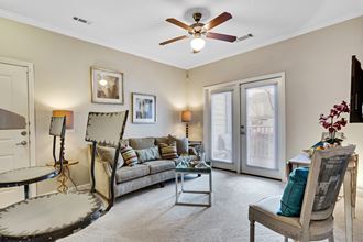 a living room with a ceiling fan and a couch