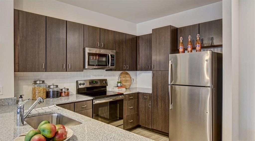 a kitchen with stainless steel appliances and wooden cabinets