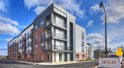 a rendering of a new apartment building on a city street