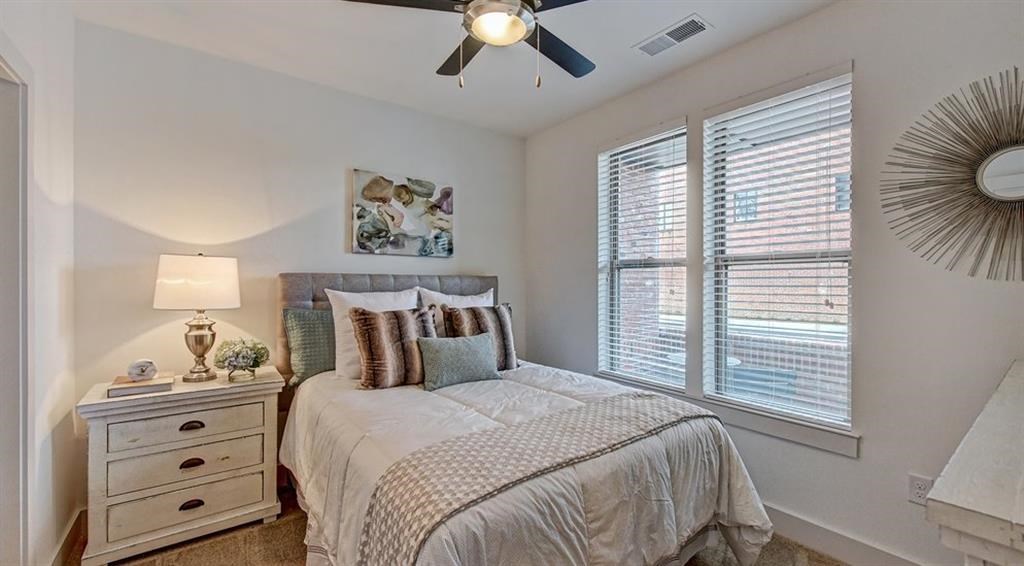 a bedroom with a bed and a ceiling fan