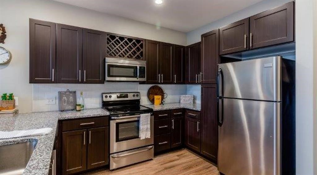 a kitchen with stainless steel appliances and wooden cabinets