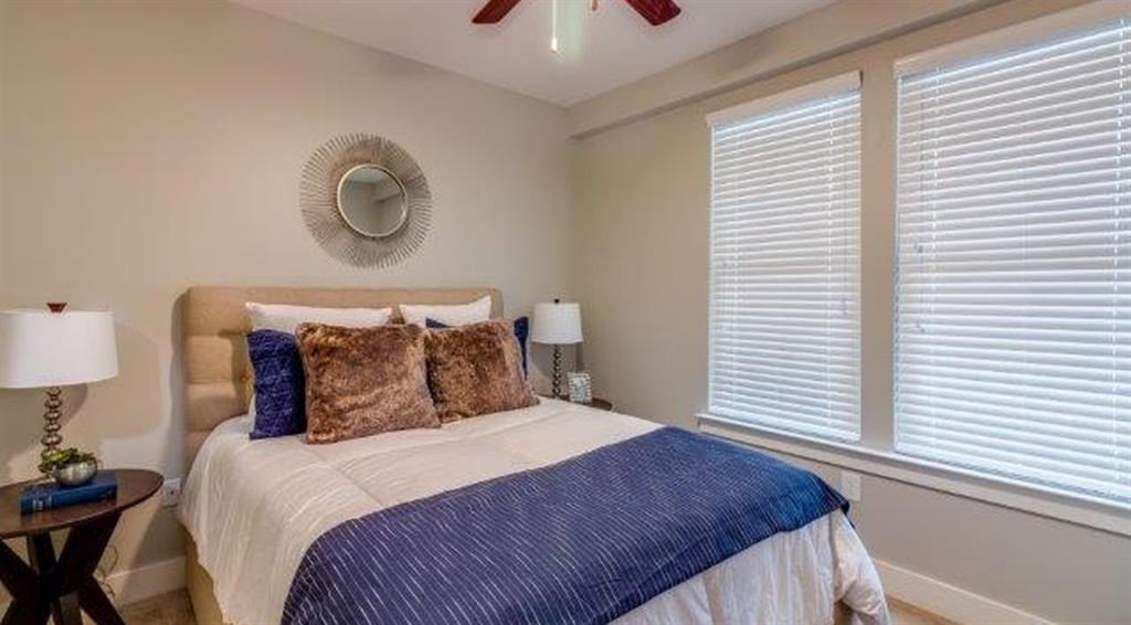 a bedroom with a bed and two windows