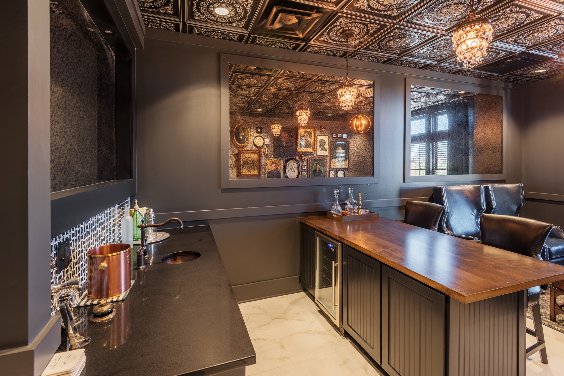 a tasting room with a bar and leather chairs and a mirrored ceiling
