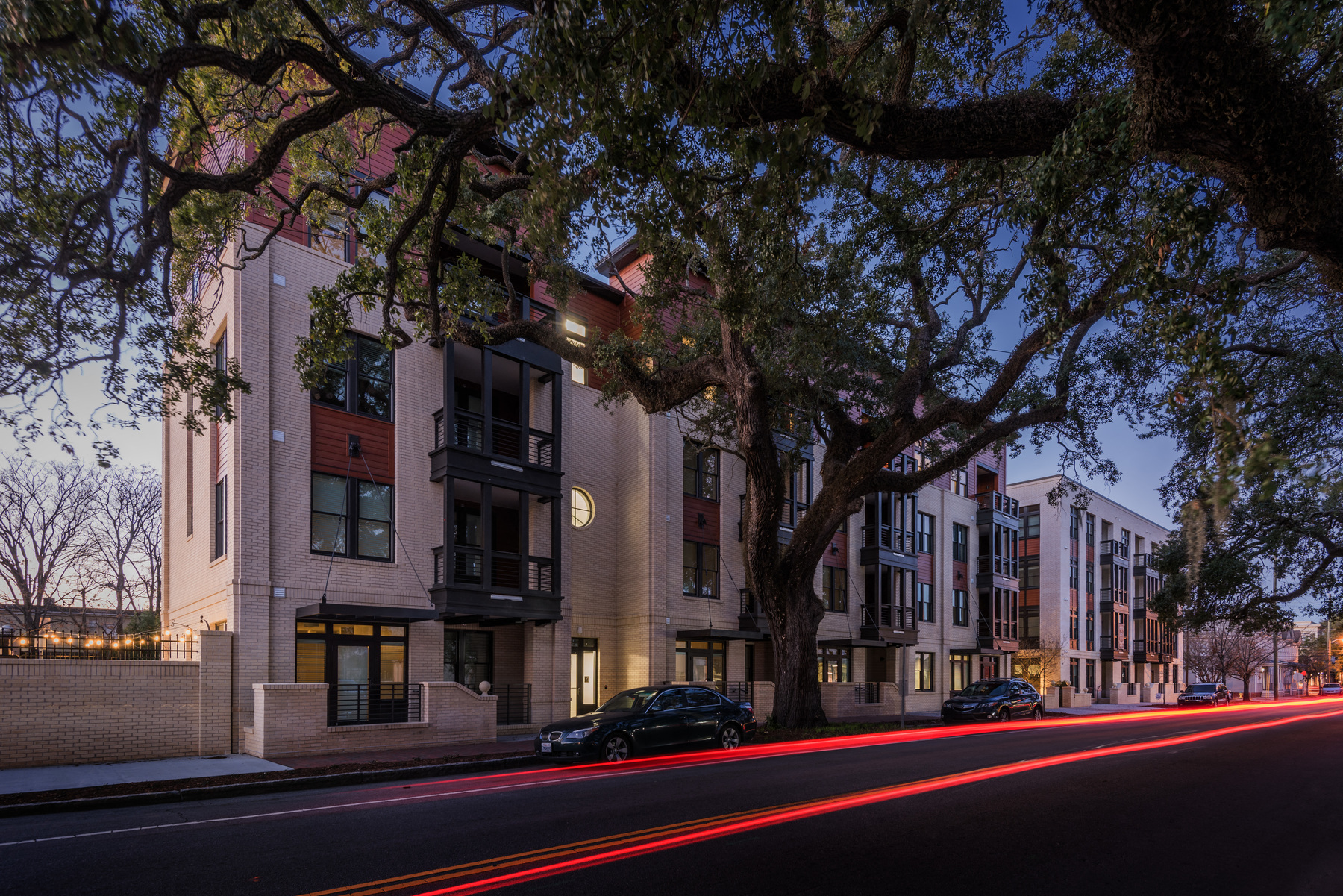 a row of apartment buildings on a city street at night