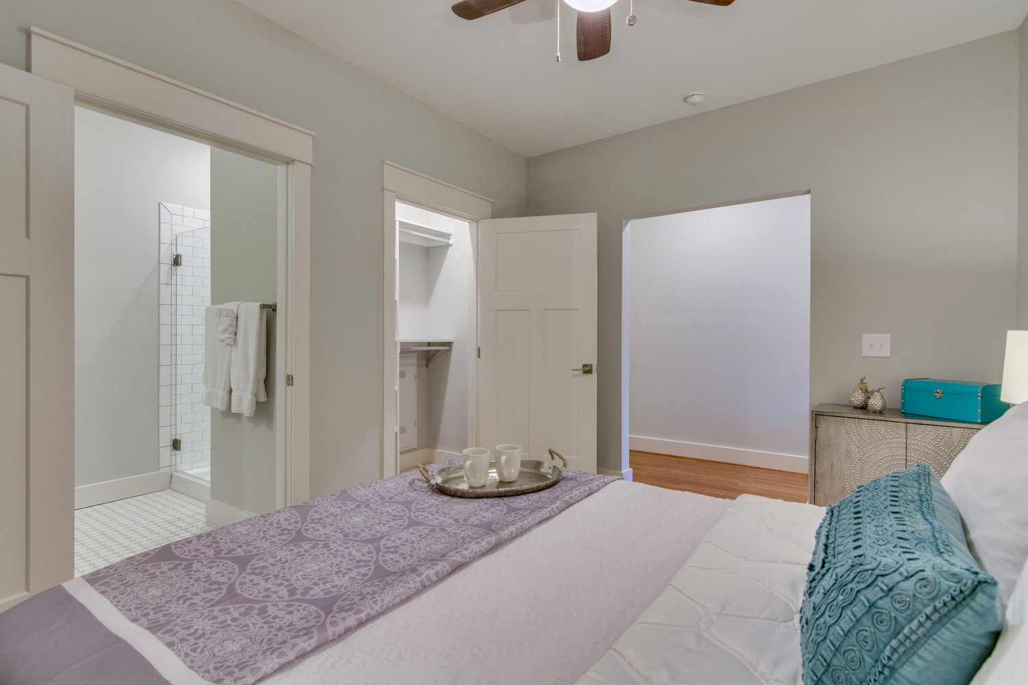 a bedroom with a large bed and a closet and a bathroom