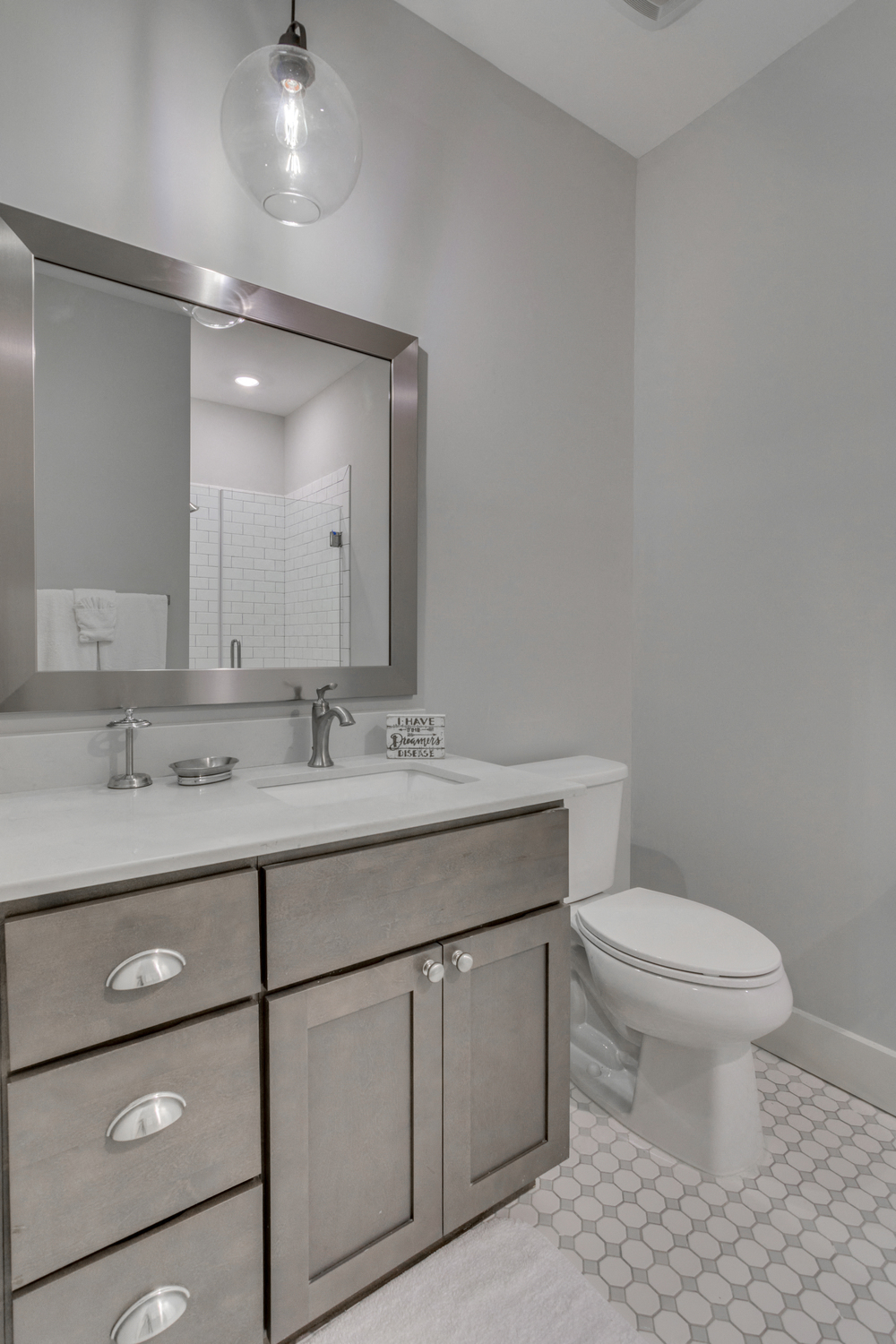 a bathroom with a toilet and a sink and a mirror