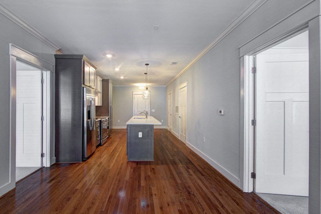 a kitchen with a center island and a wood floor