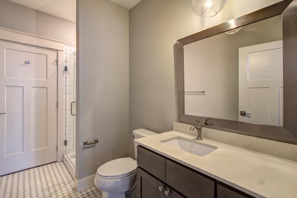 a bathroom with a toilet and a sink and a shower