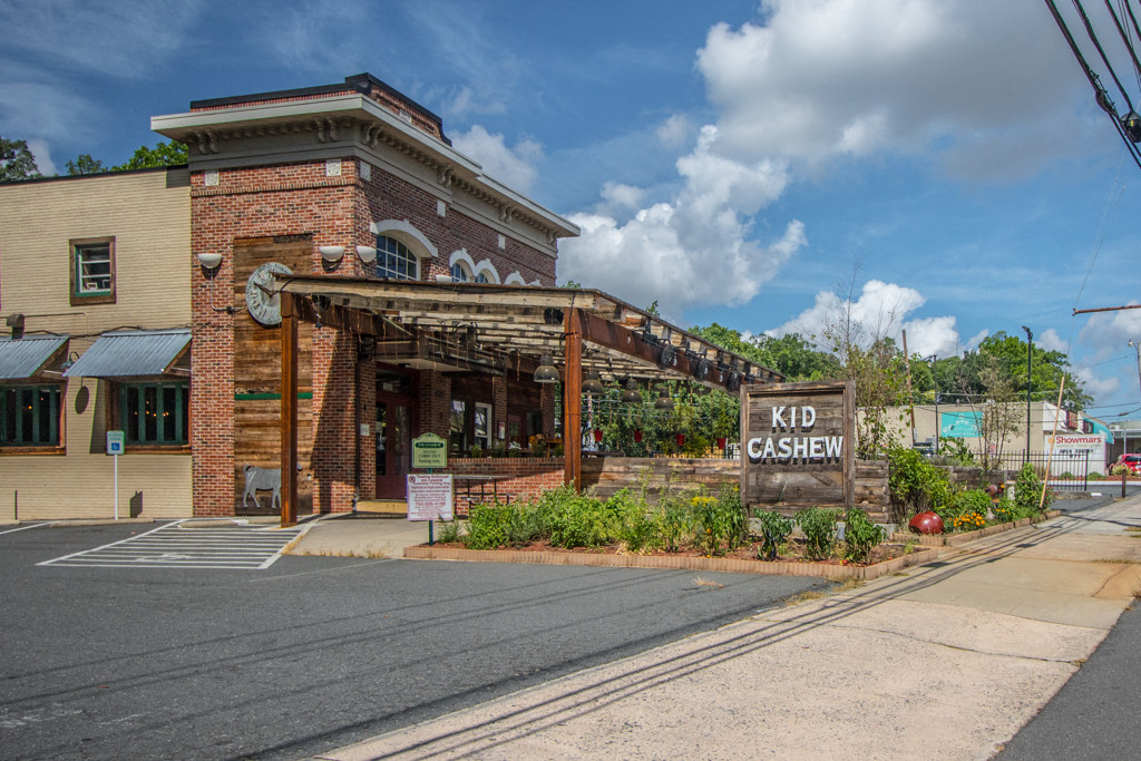 the front of a brick building with a sign that reads